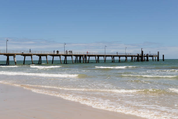 istock Looking across breaking waves toward the Glenelg Jetty 2205142633