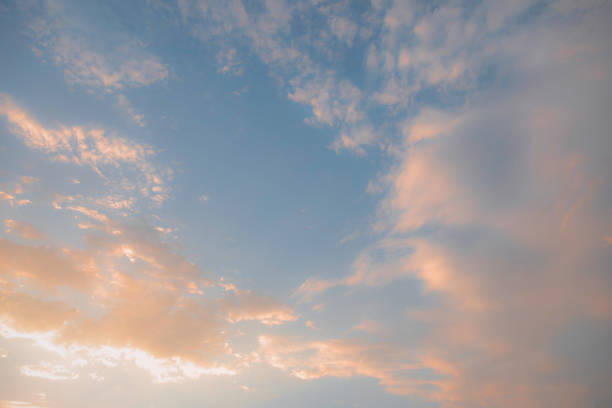 A blue sky with a few clouds and a large orange cloud. The sky is clear and the clouds are scattered throughout