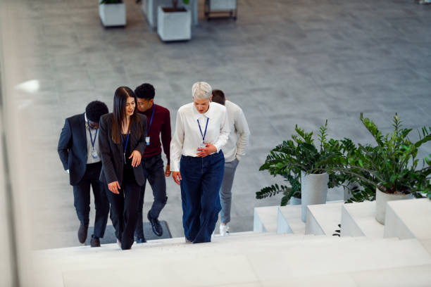 istock Group of Seminar Participants Walking in Hallway 2205147548