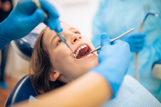istock Dentist doing dental examination on child patient. 2205154129