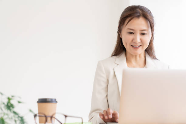istock young asian businesswoman using laptop 2205163494