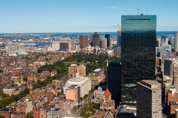 Aerial View of Boston Urban Cityscape with Modern Architecture and Bridge. Aerial view of Boston urban cityscape featuring skyscrapers, vibrant neighborhoods, sweeping bridge spanning landscape. Lush
