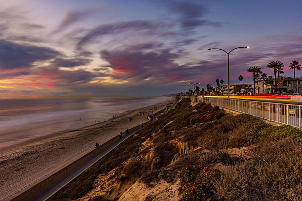 Carlsbad, California - November 30, 2024:  A beautiful blue hour view of Tamarack Surf Beach with light trail from traffic on Carlsbad Blvd.  HDR encoded