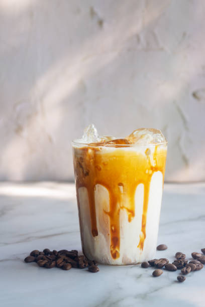 istock ice caramel macchiato coffee on white table. 2205171115