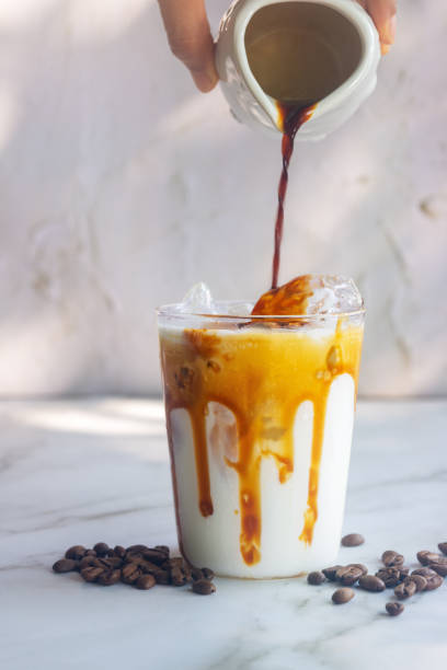 istock ice caramel macchiato coffee on white table. 2205171129