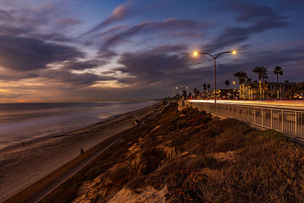 Carlsbad, California - November 30, 2024:  A beautiful blue hour view of Tamarack Surf Beach with light trail from traffic on Carlsbad Blvd.  HDR encoded