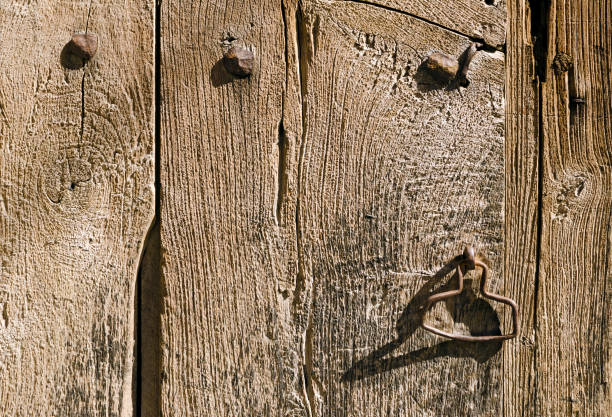 Close up of a handle on the old wooden door in an abandoned house