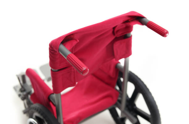 istock Back view of wheelchair with red handle bars and seat. 2205175744