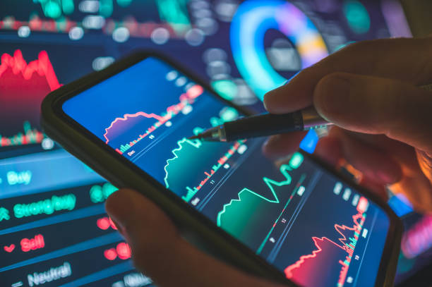istock Professional businessman using a Millennial businesswomen using a tablet artificial intelligence model cha artificial intelligence model charts displaying a smart trading interface powered AI  with detailed charts and graphs for informed trading decisions 2205180000