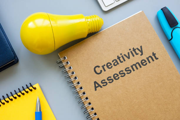 istock Creativity assessment report and yellow bulb. 2205184248
