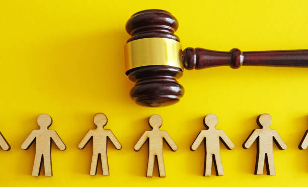 istock Figurines and one next to a gavel. Justice and legal decisions. 2205184272