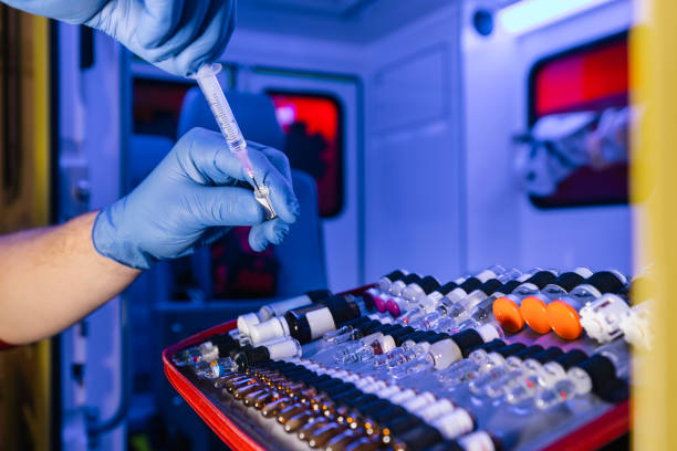 Paramedic hands holding ampoule with medication in ambulance