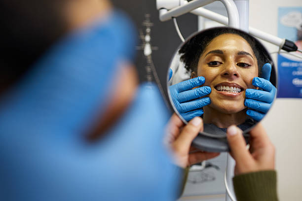 istock Smiling Patient Checking Reflection During Dental Check-Up with Dentist Assistance 2205186807