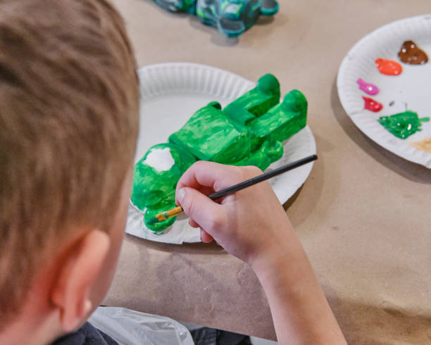 Child Painting Plaster Bear Figurine