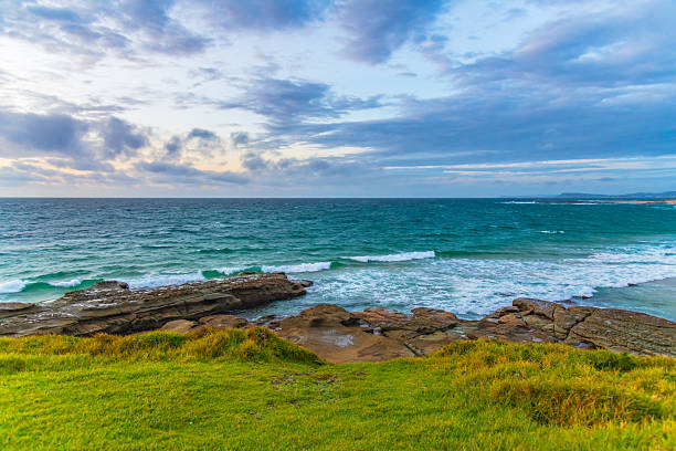 A windy Sunrise over the sea from Soldiers Beach at Norah Head, NSW, Australia.