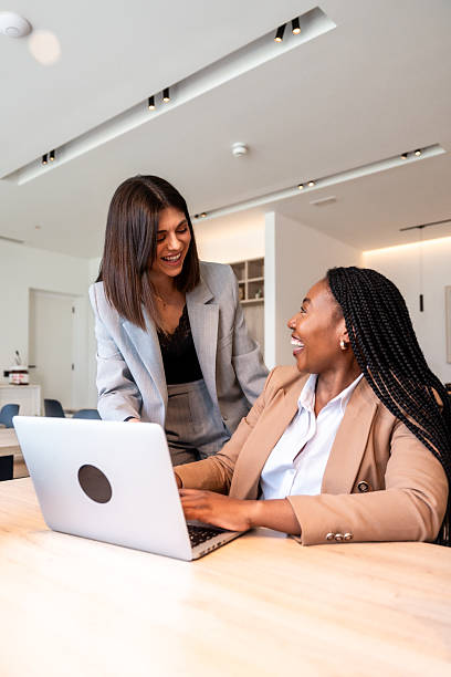 istock Female executives collaborating on laptop during business trip 2205194295