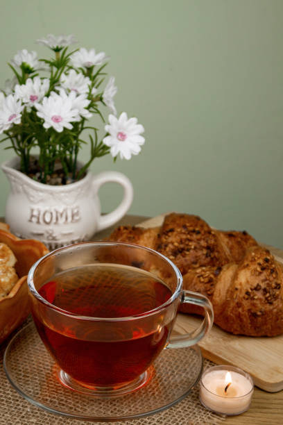 Croissants and tea on the table, view from above. Delicious aromatic breakfast. High quality photo