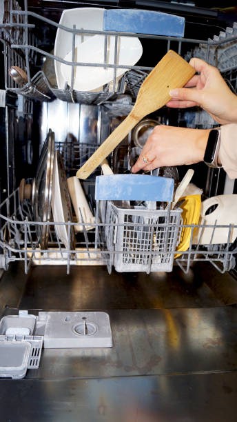 istock young woman and open dishwasher 2205202707