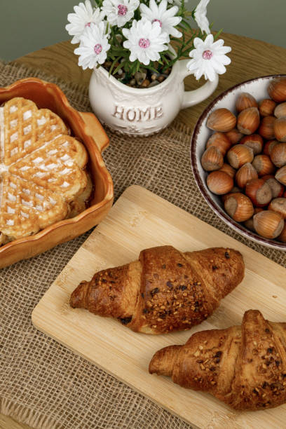 istock Croissants and hazelnuts on the table. Delicious healthy breakfast. Top view 2205202944