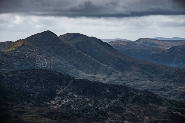 istock The landscape is rugged. Steep mountains and deep valleys, surrounded by ominous clouds that hint at changing weather. The views are a testament to the essence of nature's raw beauty. 2205203480