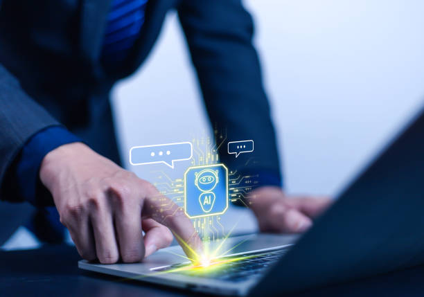 istock Businessman using AI robot technology. A man uses a laptop to talk to AI artificial intelligence. Future technology. 2205204025