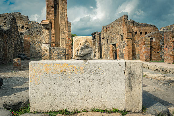 Herculaneum, Campania, Italy - June 29, 2021: Ruins of  ancient city destroyed by the eruption of the volcano Vesuvius in 79 AD near Naples, Archaeological Park of Ercolano. Statue of Marcus Nonius Balbus