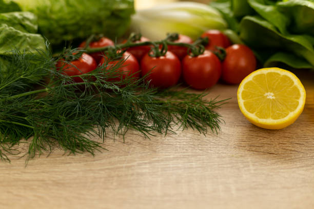 Red tomatoes, lettuce leaves on the table close-up. Vegetables for salad on the kitchen table. High quality photo