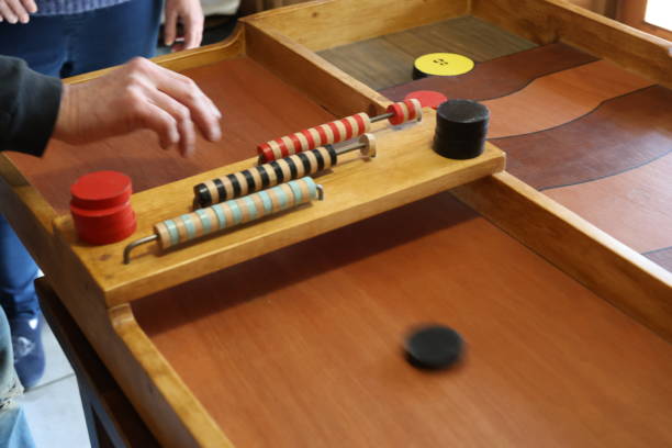 istock A senior man is launching a puck for a wooden game 2205208882