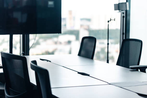 istock Modern empty office meeting room with glass windows and mesh chairs 2205209293