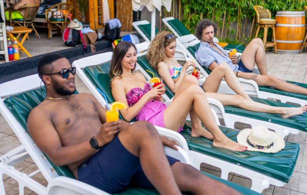 istock Friends relaxing by the pool 2205209849