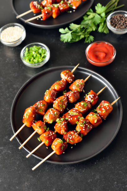 istock Teriyaki chicken skewers on plate 2205210095