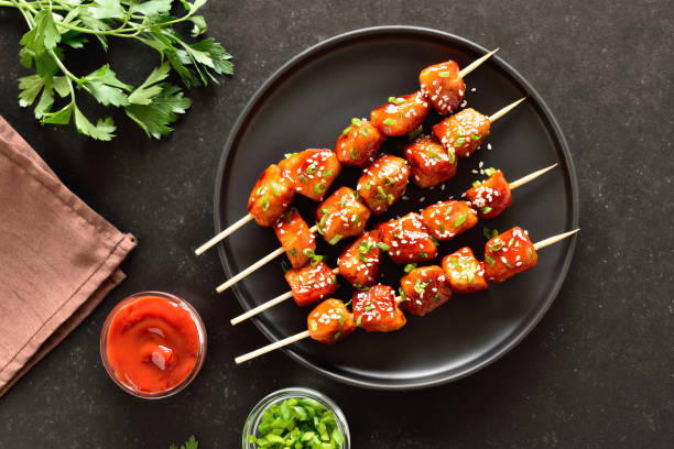 istock Teriyaki chicken skewers on plate 2205210099