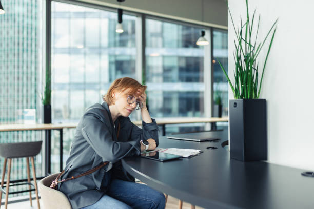 istock Woman Experiencing Stress While Working in a Modern Office Environment 2205212398