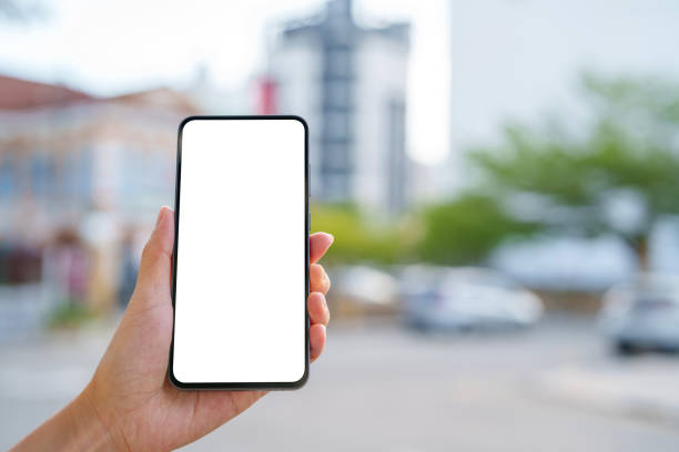 istock Hand Holding Smartphone with Blank Screen Outdoors By The Street 2205212403