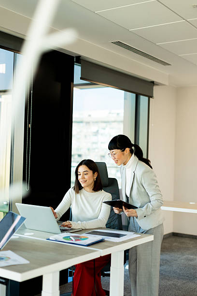 istock Women collaborating in a modern office space during a productive business meeting 2205212533