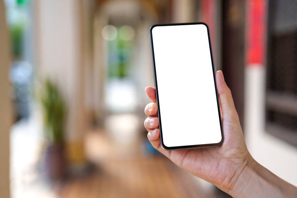 istock Hand Holding Smartphone with Blank Screen in Urban Walkway 2205214279
