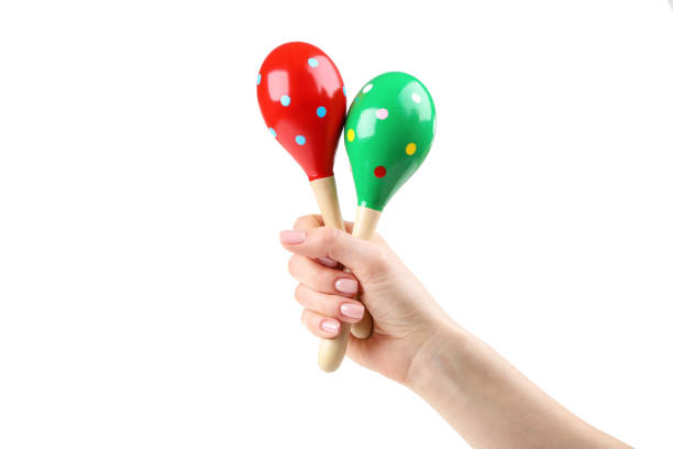 istock Mexican maracas in female hand on white background 2205216893