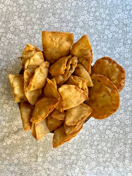 istock Yarimca burek Beef Cheburek on a wooden table. Deep Fried Beef Dumplings with meat and onions. Turkish name Ci Borek or Cig Borek 2205219257