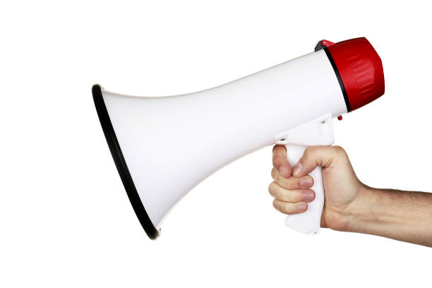 istock Female hand holding megaphone on white background 2205220368