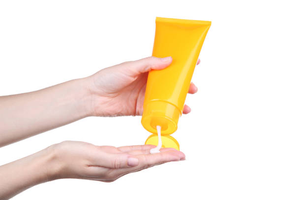 istock Female hand holding sunscreen cream on white background 2205220825