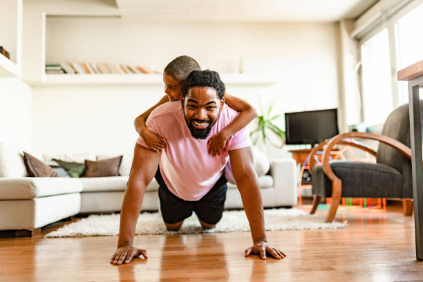 istock Father and Child Exercising Together at Home 2205224576