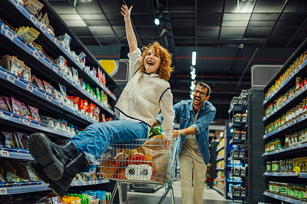 istock Couple having fun while grocery shopping in supermarket 2205225054