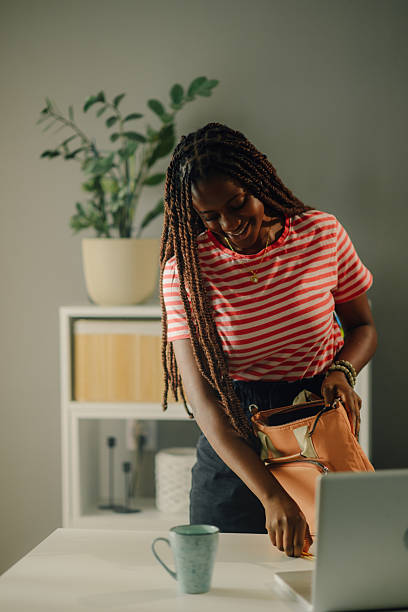 istock Young woman getting ready to leave the office after work 2205225113