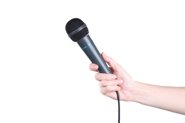 istock Female hand holding microphone on white background 2205225699