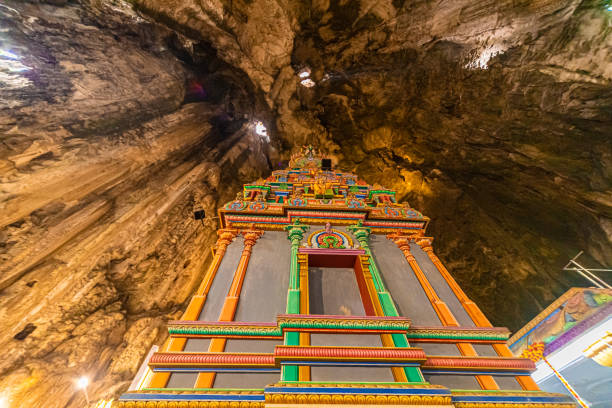 Batu Caves Temple, located just outside Kuala Lumpur, Malaysia, is an iconic Hindu shrine dedicated to Lord Murugan. Set against a stunning limestone hill backdrop, it features vibrant, colorful steps leading up to a series of caves and temples. Its most striking feature is the colossal golden statue of Lord Murugan at the entrance, making it a breathtaking and culturally rich destination. The temple is especially vibrant during the annual Thaipusam festival, attracting visitors from around the world.