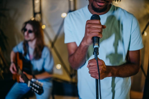 istock Handsome young man singing in the studio 2205227060