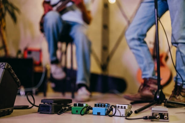 Talented bass guitarist playing his instrument in the studio