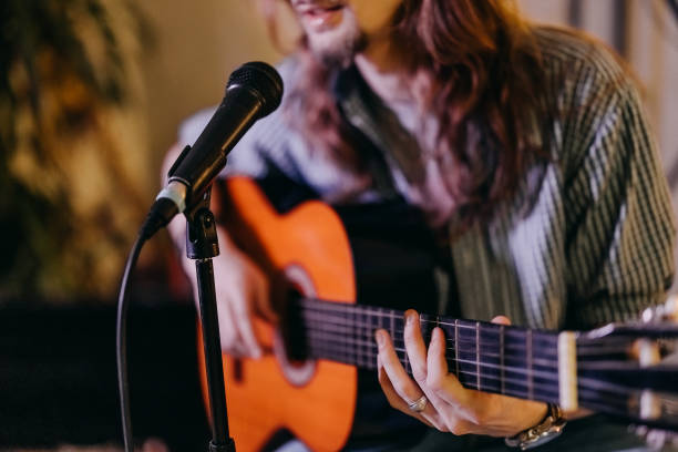 istock Musician sings and plays guitar 2205227162