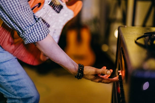 Talented bass guitarist playing his instrument in the studio