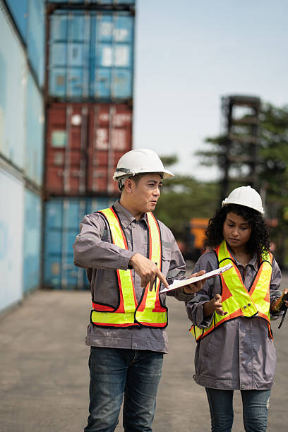 istock Asia supervisor worker man and woman working with checking container at container site 2205228313